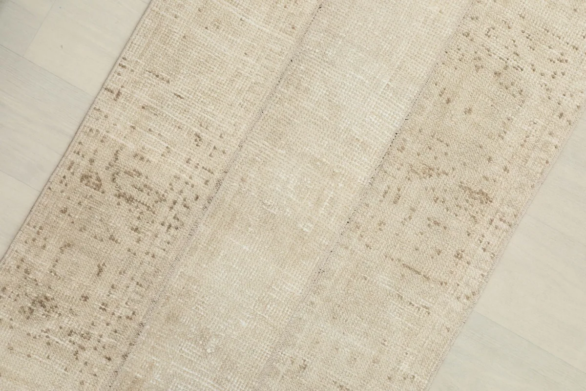 Close-up view of the rug's surface showing the distinct vertical panels and faded texture