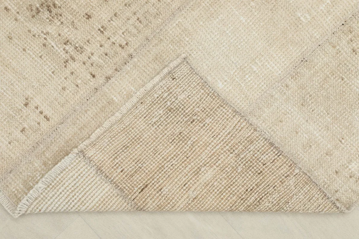 Underside of the rug, revealing the hand-knotted cotton foundation and wool pile construction