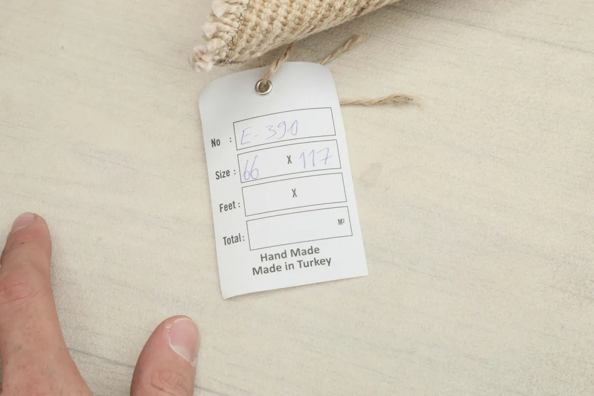 Product tag indicating the rug's dimensions in centimeters and 'Hand Made in Turkey'
