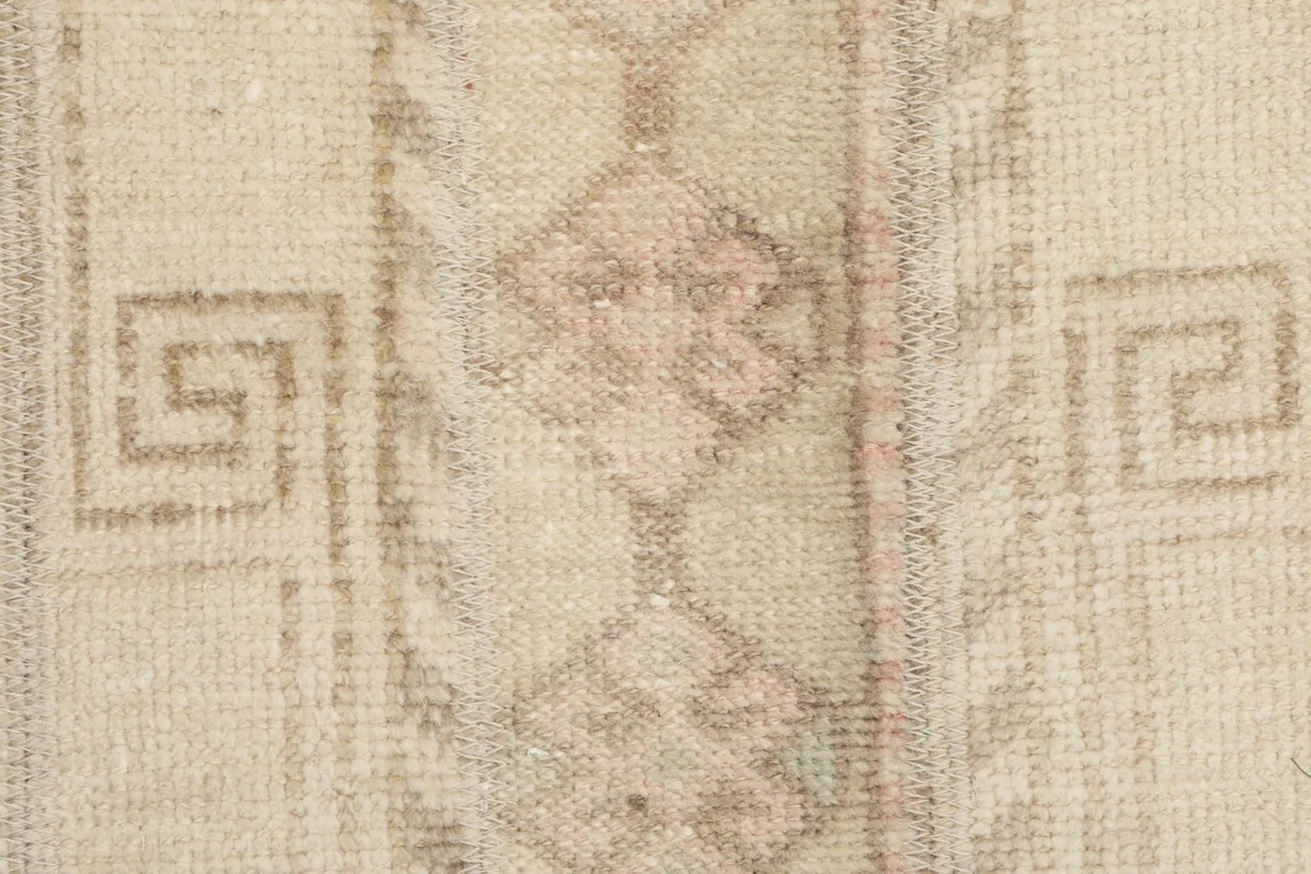 Macro shot of the low wool pile, showing individual knots and distressed areas