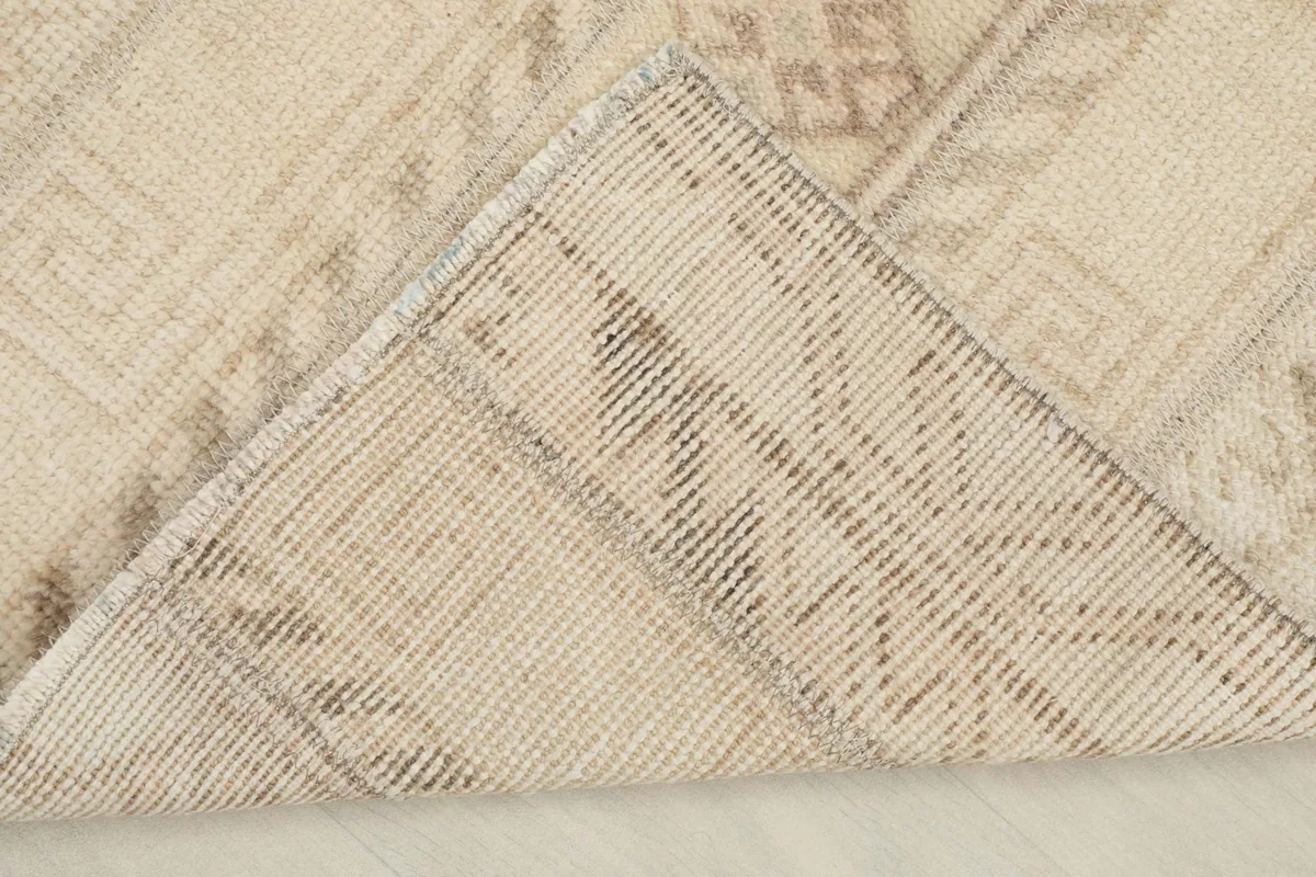 View of the rug's back, revealing the cotton foundation and hand-knotted construction