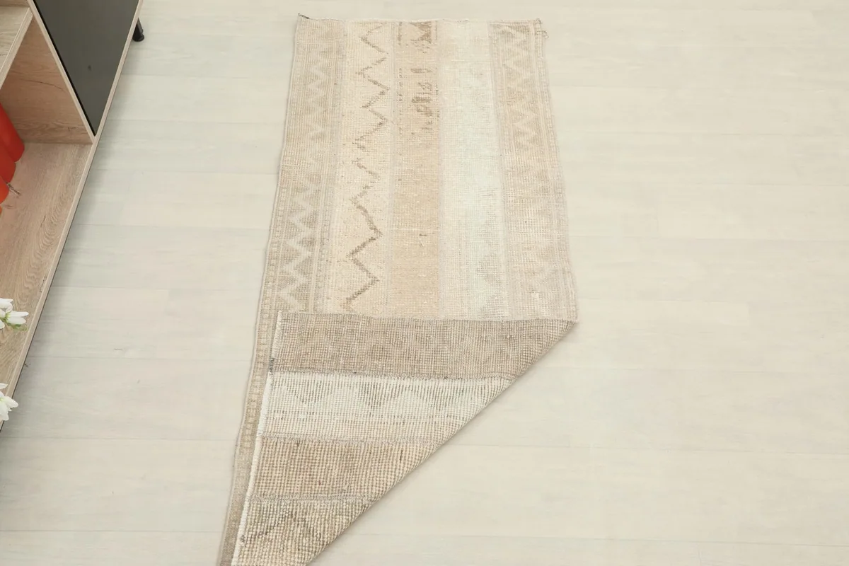Full view of the runner with one corner folded back, showing the back of the rug