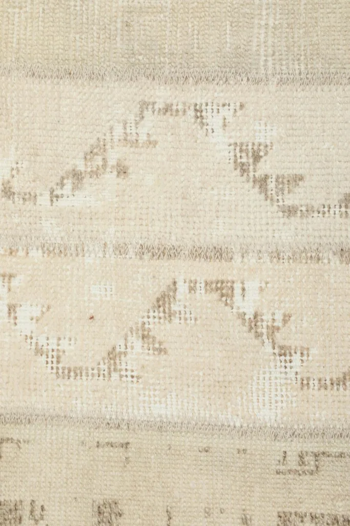 Macro detail of the hand-knotted wool pile and the geometric motifs