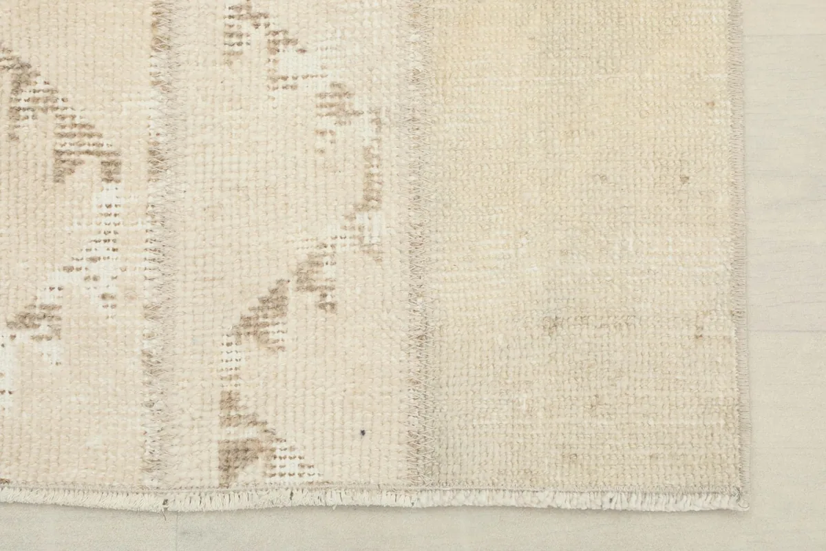 Close-up of the lower right corner, showing the rug's edge and subtle patina
