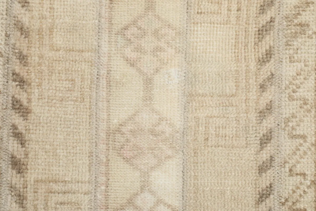 Detailed view of the central geometric motifs and the low pile texture