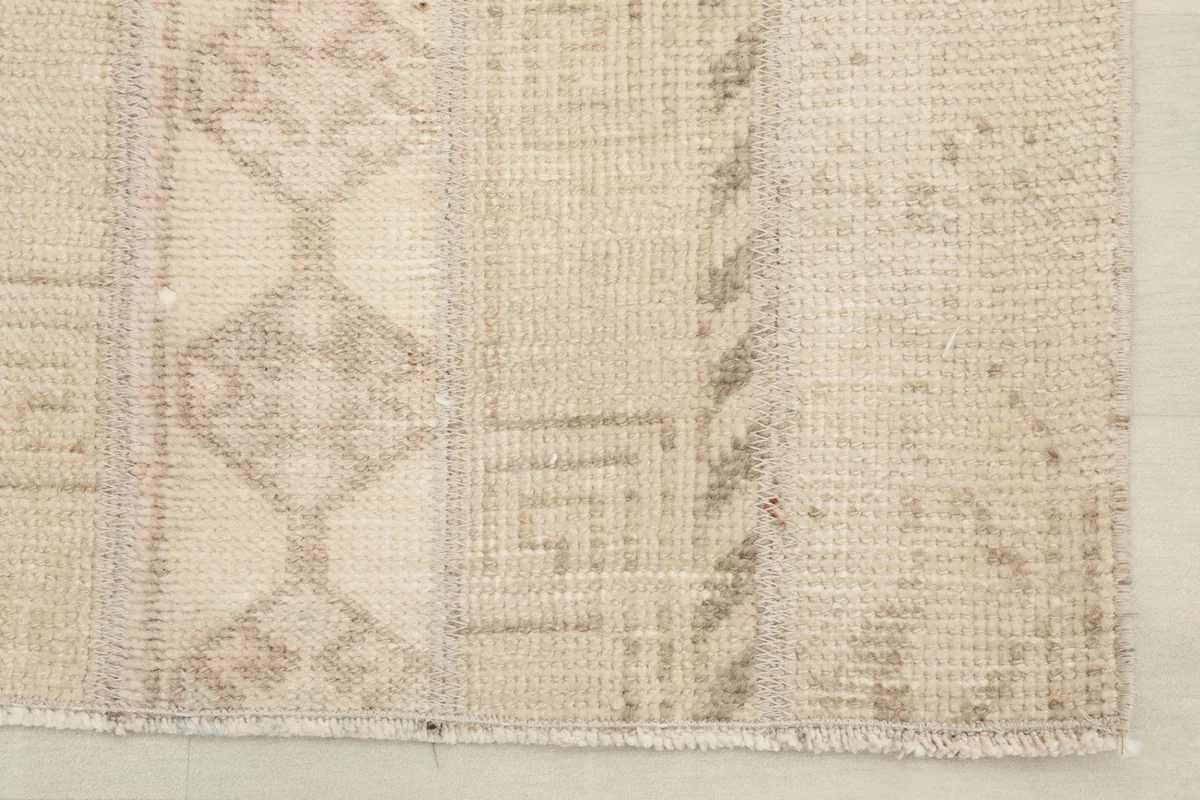 Close-up of the rug's edge and fringe, showing the hand-knotted construction