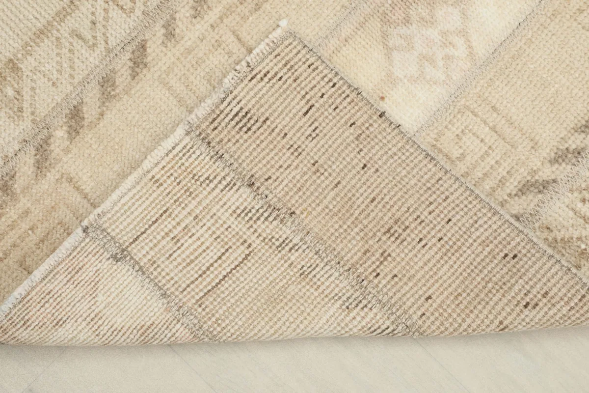 View of the back of the rug, revealing the tightly woven cotton foundation