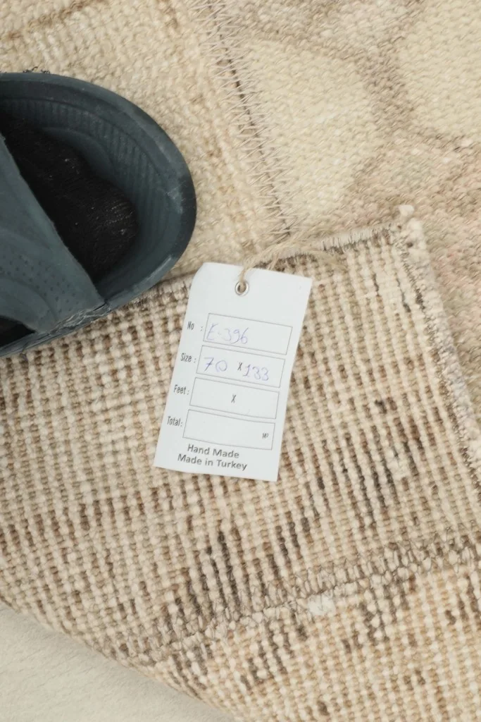 Close-up of the rug's texture and the 'Hand Made in Turkey' product tag