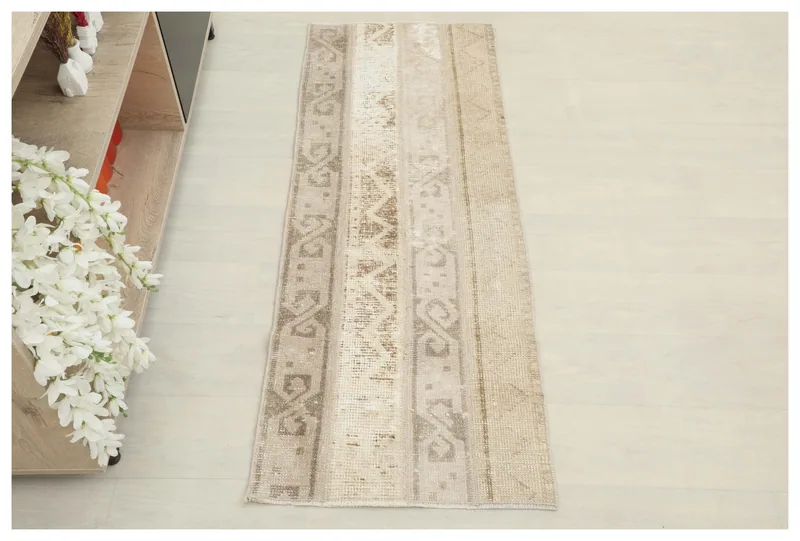 Full top view of the beige geometric patchwork runner rug on a white background.