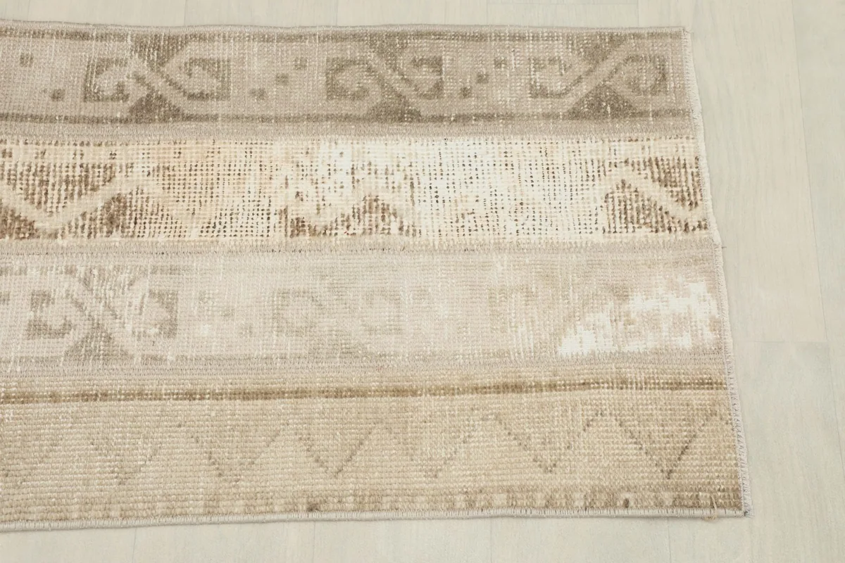 Overhead view showing the distinct geometric patterns and color variations across the rug's width.