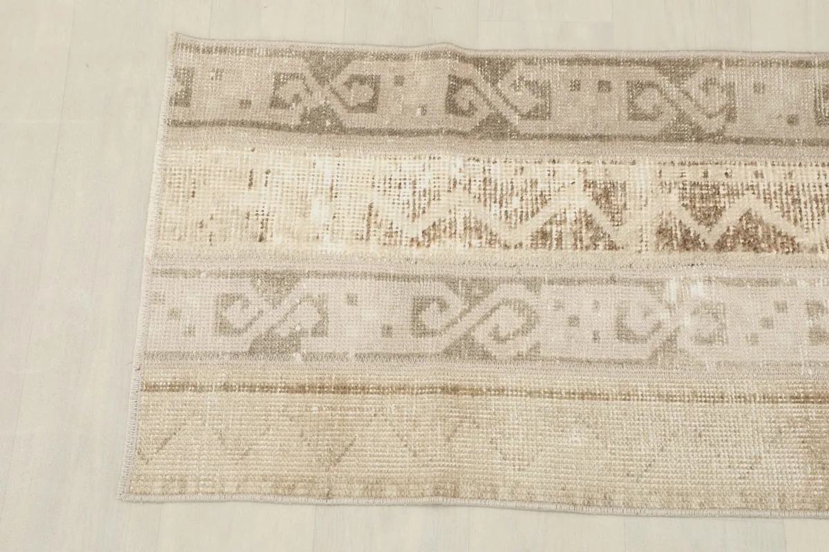 Overhead view of the other end of the beige runner, highlighting its unique tribal designs.