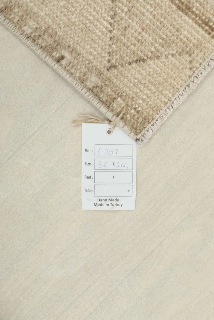 Close-up of the product tag indicating the rug's size and origin, next to the rug's corner.