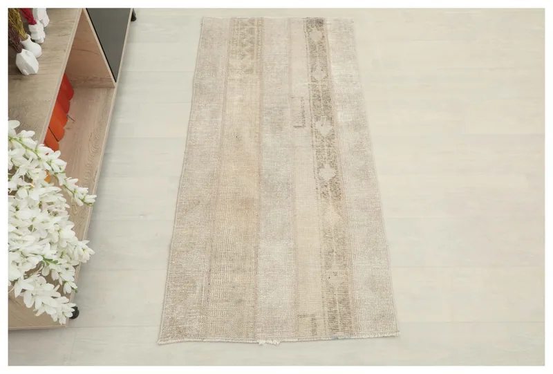 Full top view of the 2x4 beige patchwork Anatolian rug on a white background