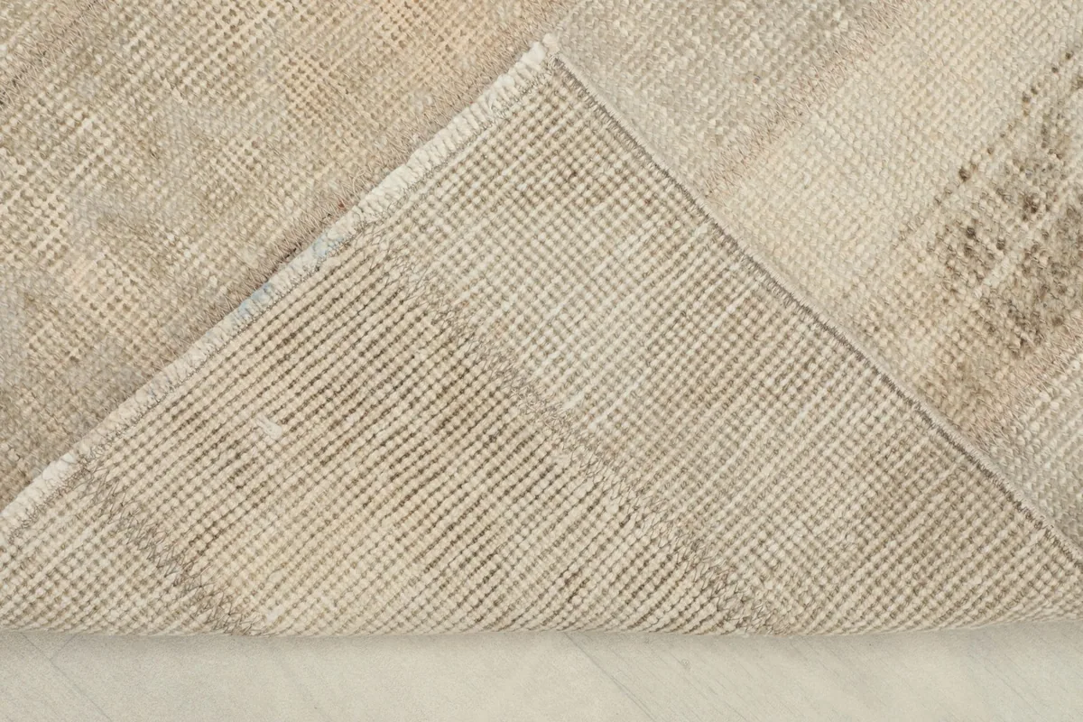 View of the rug's back, showing the tightly woven cotton foundation