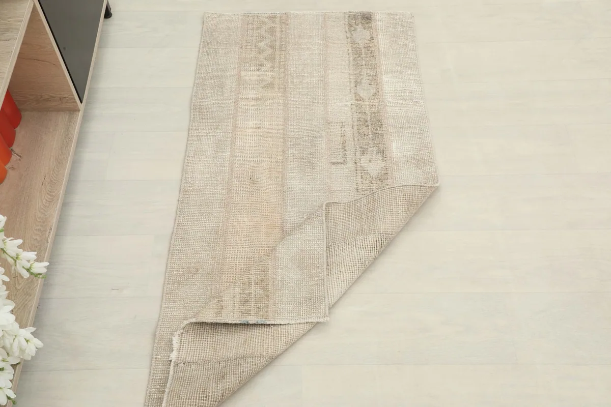 Rug partially folded, displaying both the top surface and the back