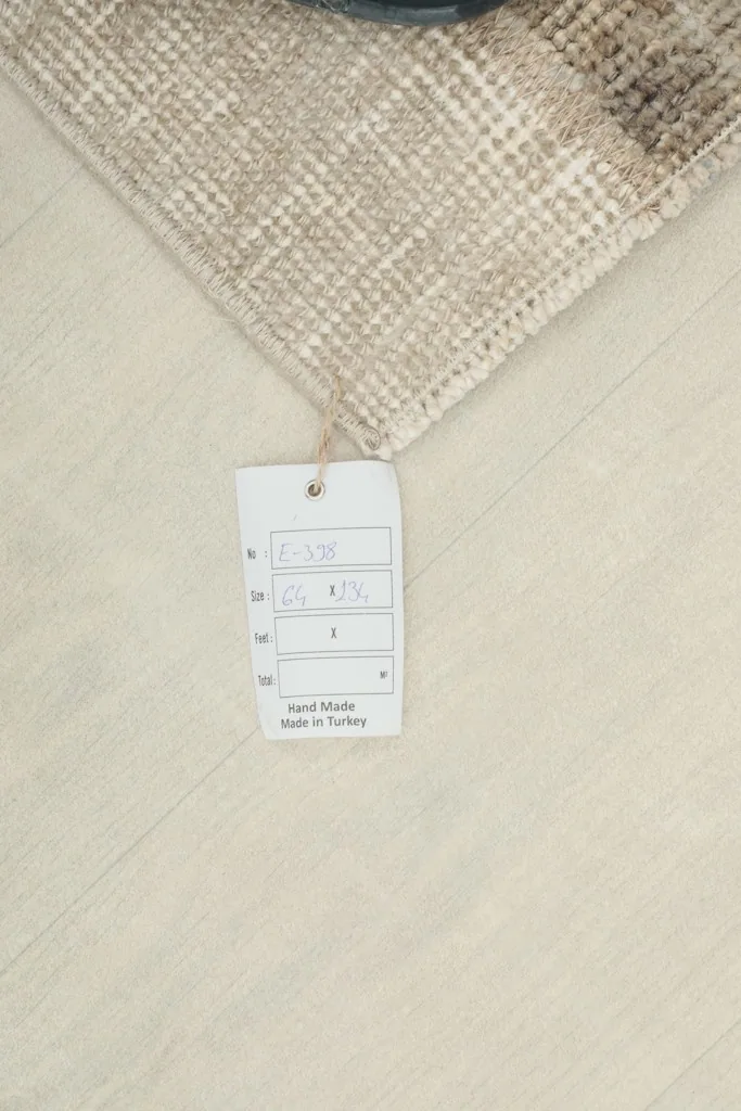 Rug tag displaying product information, including hand-made in Turkey