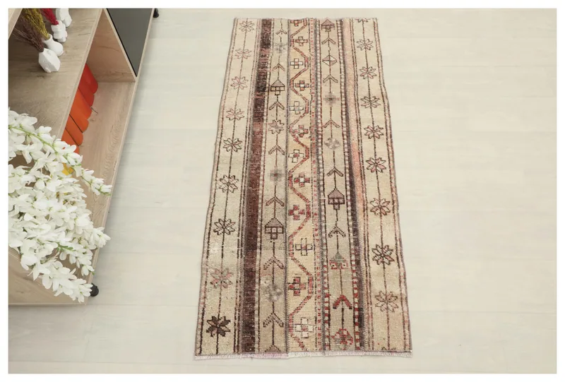 Full top view of the 2x5 beige tribal striped vintage rug on a white background.
