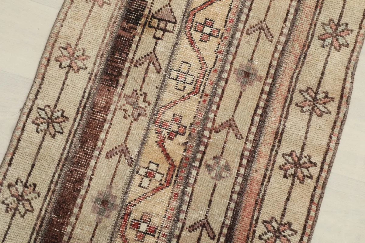 Overhead close-up of the rug's surface, revealing the intricate tribal motifs and color variations.