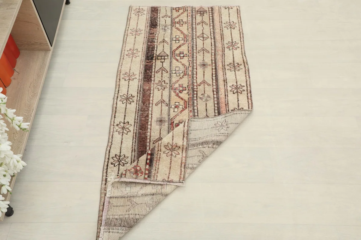 Full top view of the rug with one corner folded back, revealing the underside.