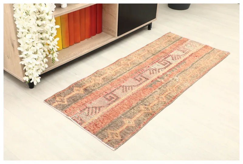 Full top view of the rust and beige striped tribal runner rug on a white background.