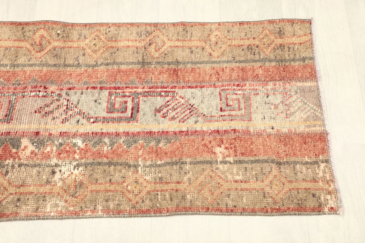 Close-up of the other end of the rug, highlighting the unique wear and patina.