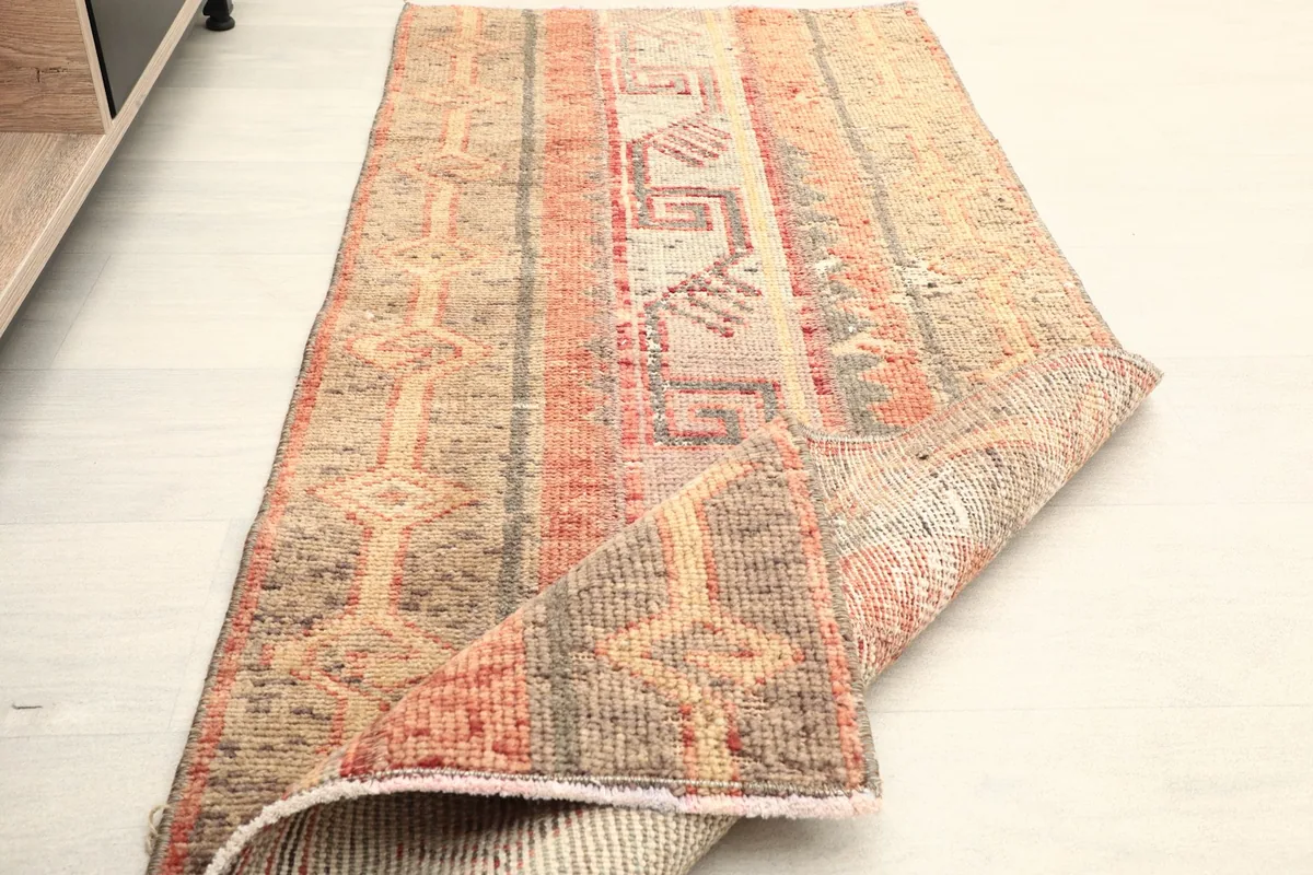 The rug folded to show its flexibility and thickness, with the back visible.