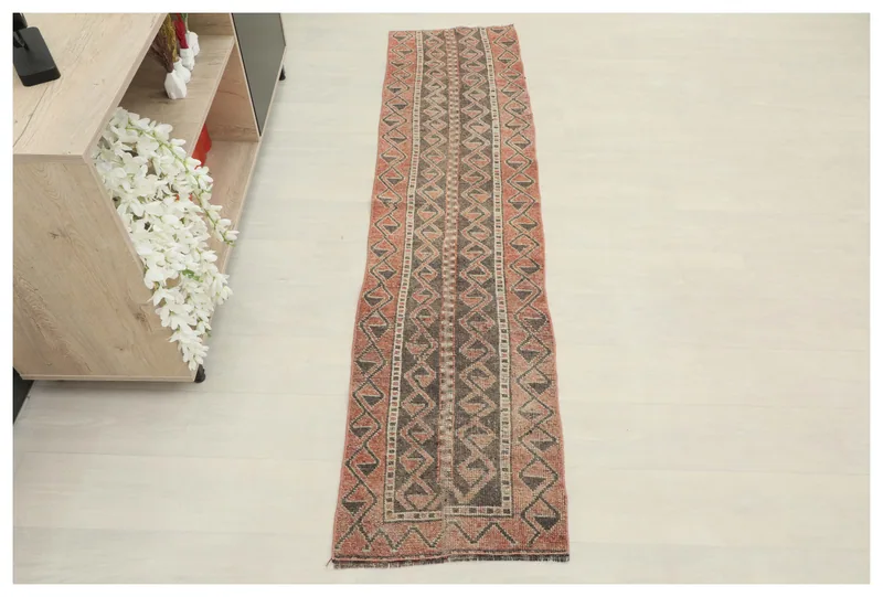 Full overhead view of the rust and charcoal tribal geometric vintage runner rug