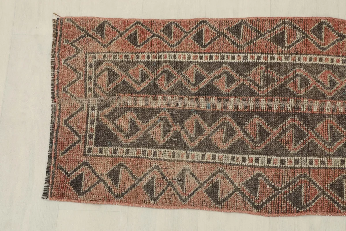Close-up of one end of the runner, highlighting the geometric patterns and border design