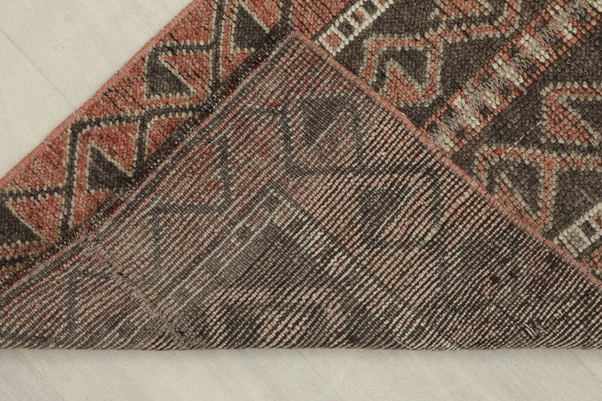 View of the back of the hand-knotted rug, revealing the cotton foundation and knotting