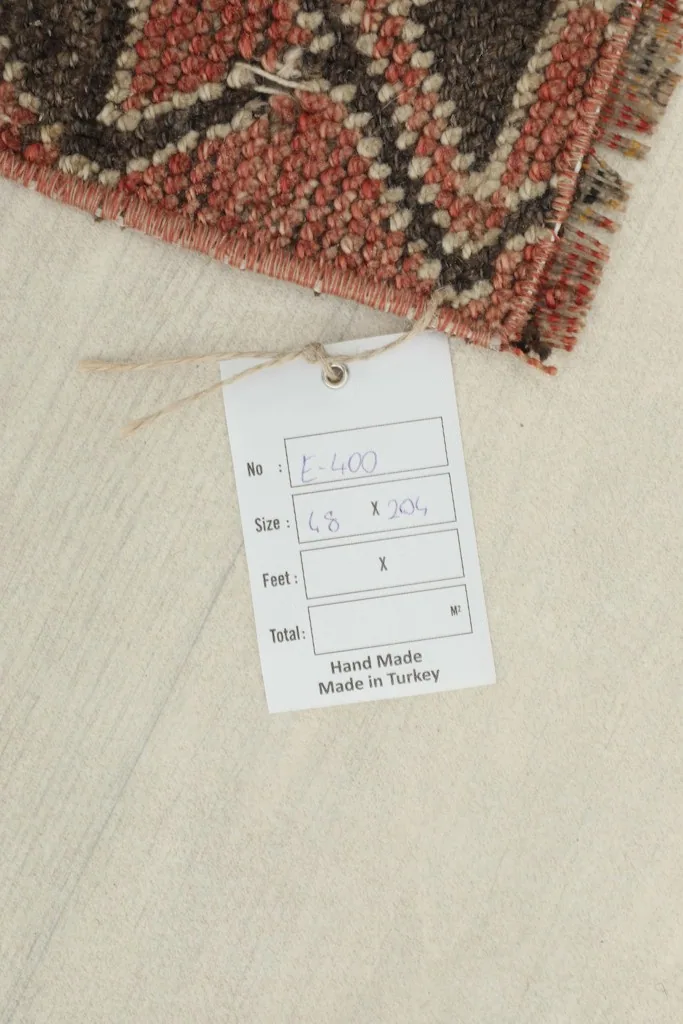 Close-up of the product tag indicating the rug is handmade and made in Turkey