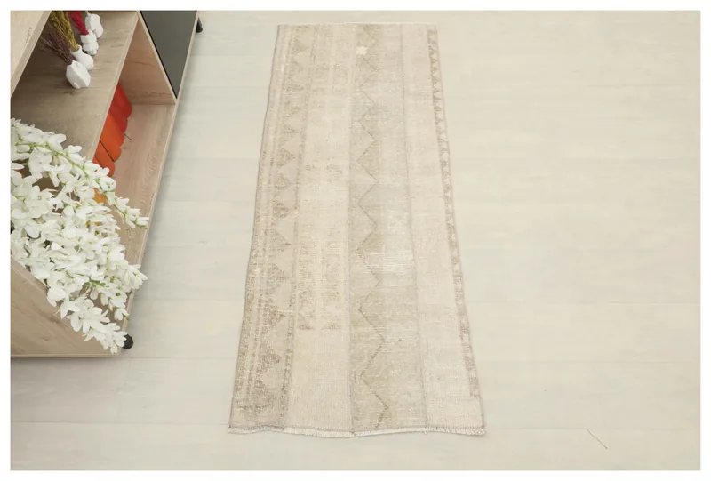 Full overhead view of the 2x5 tan striped geometric runner on a light floor.