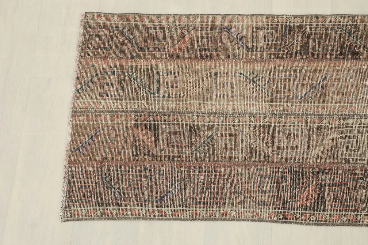 View of the other end of the rug, showing the border and fringe details.