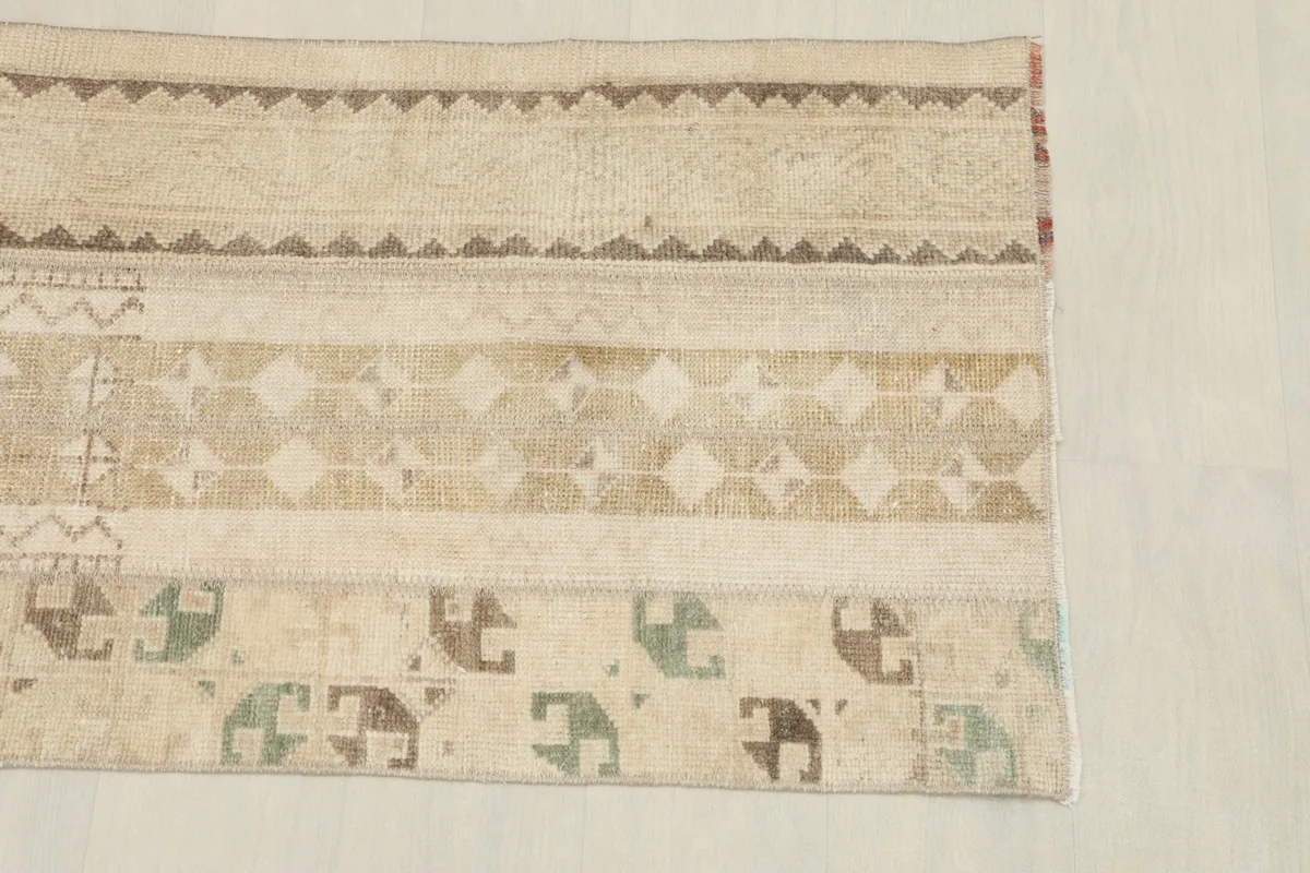 Detailed section showing the distinct striped design with geometric motifs and muted olive accents.