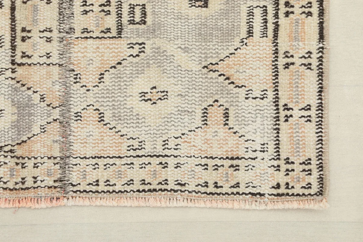Close-up of the hand-knotted wool pile and the intricate tribal patterns