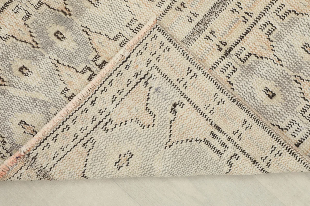 View of the back of the hand-knotted rug, showing the cotton foundation