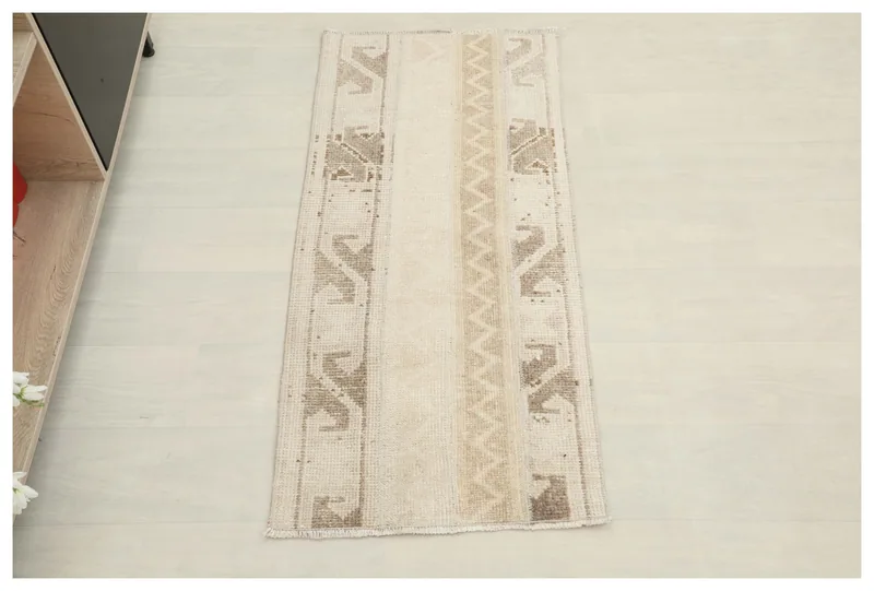 Full top view of the beige and brown vintage Anatolian tribal geometric rug