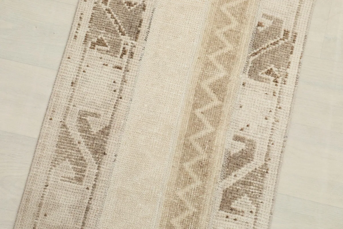 Close-up detail of the beige and brown geometric patterns and texture