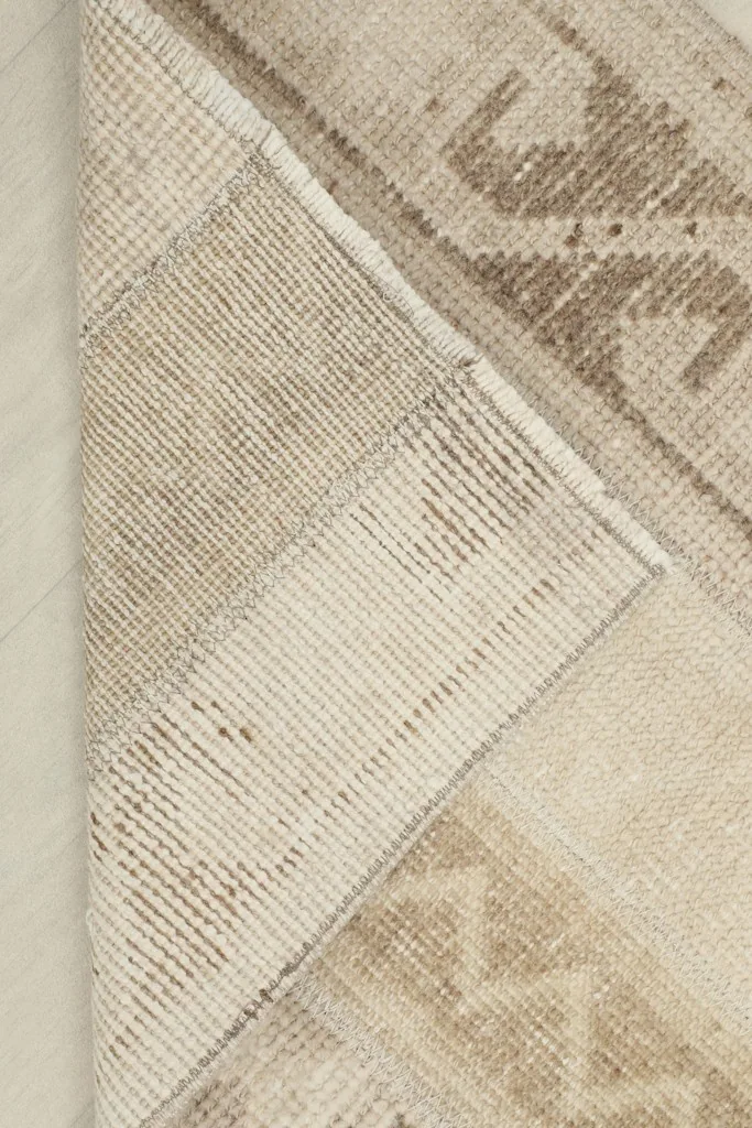 View of the cotton foundation and hand-knotted construction from the back of the rug