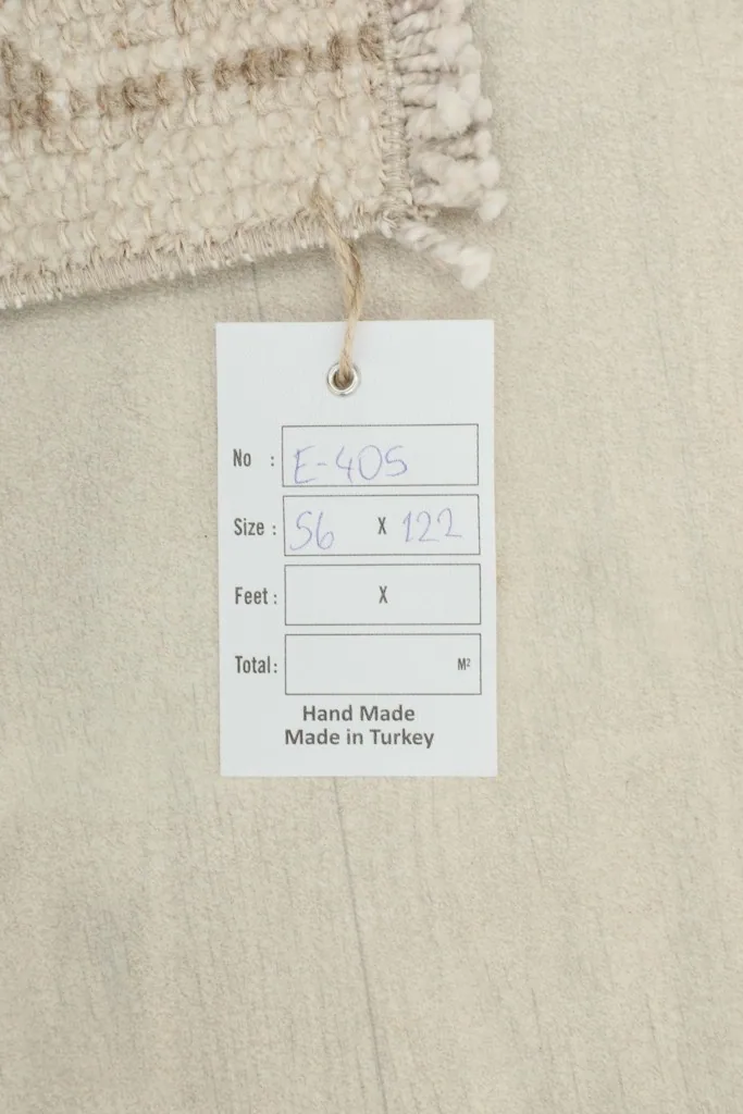 Product tag displaying the rug's dimensions in centimeters, confirming hand-made origin