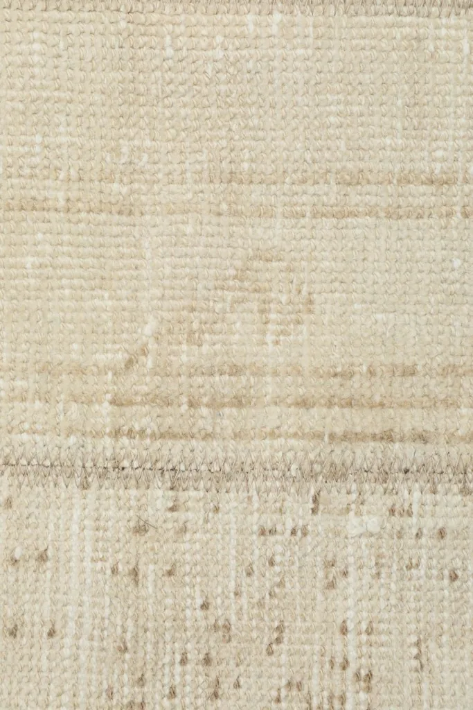 Detailed view of the low pile and texture of the vintage wool rug