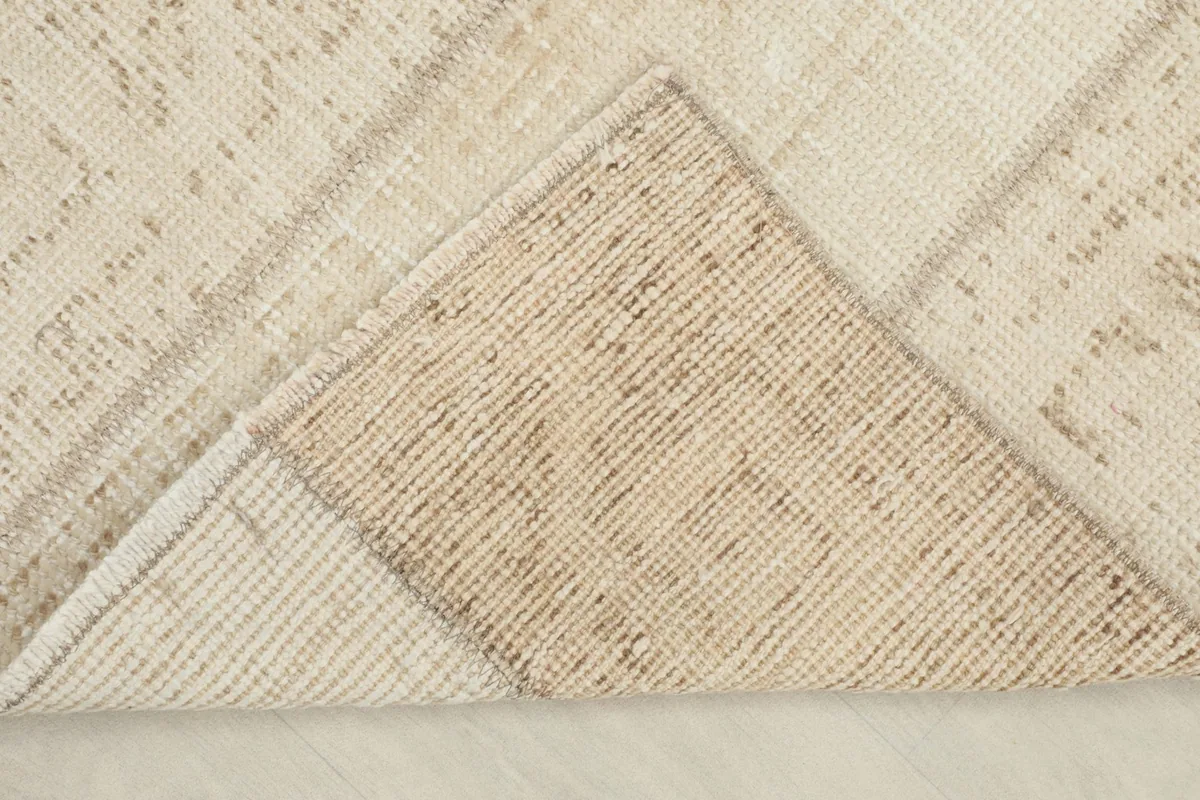 Underside view of the rug, revealing the cotton foundation and hand-knotted construction