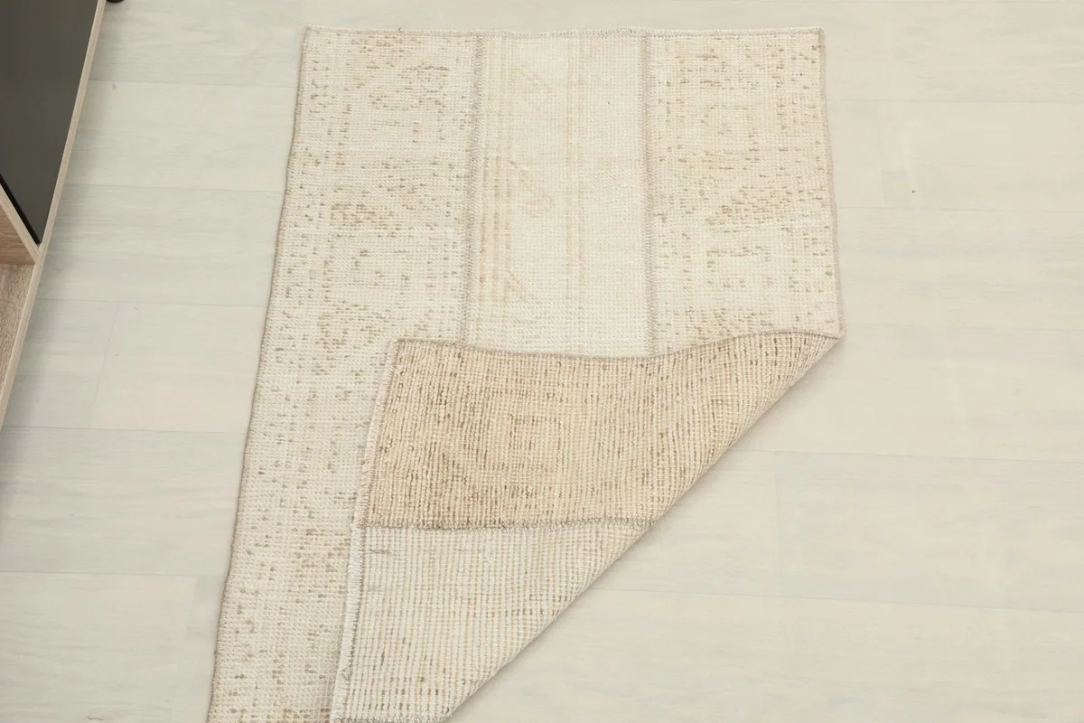 Rug partially folded, displaying both the top surface and the reverse side