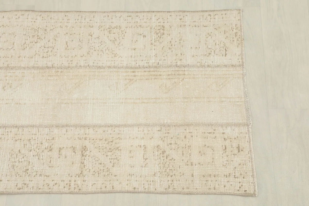 Overhead view focusing on the central and side panels of the patchwork geometric rug