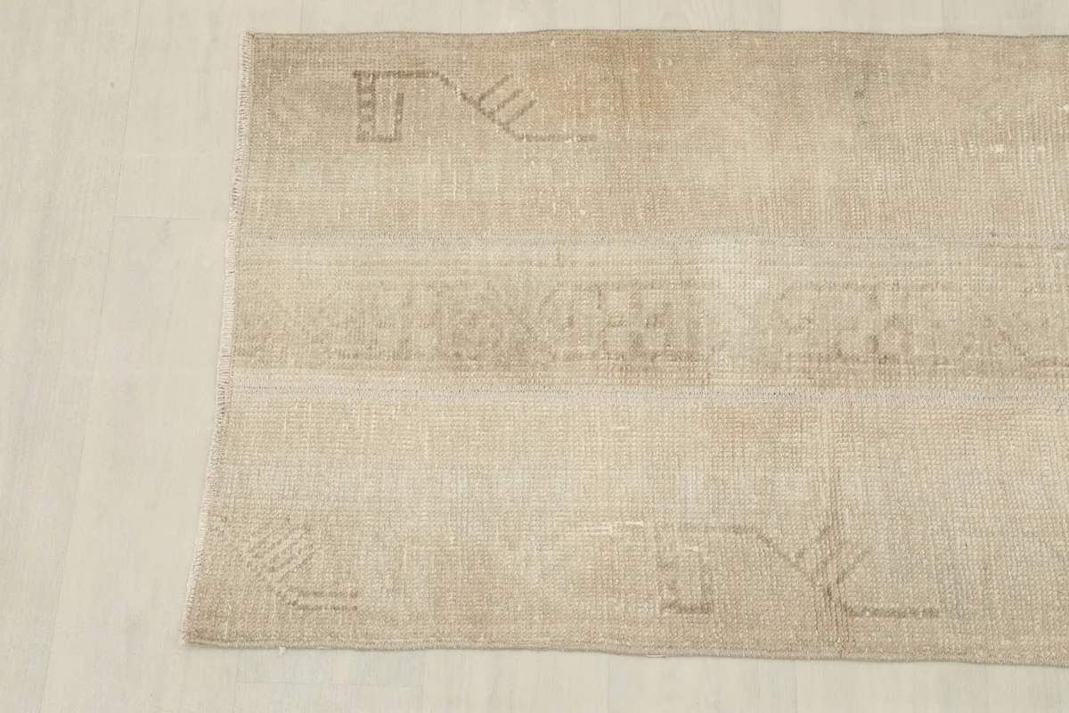 Close-up of the other end of the rug, revealing the soft, muted tones and hand-knotted details