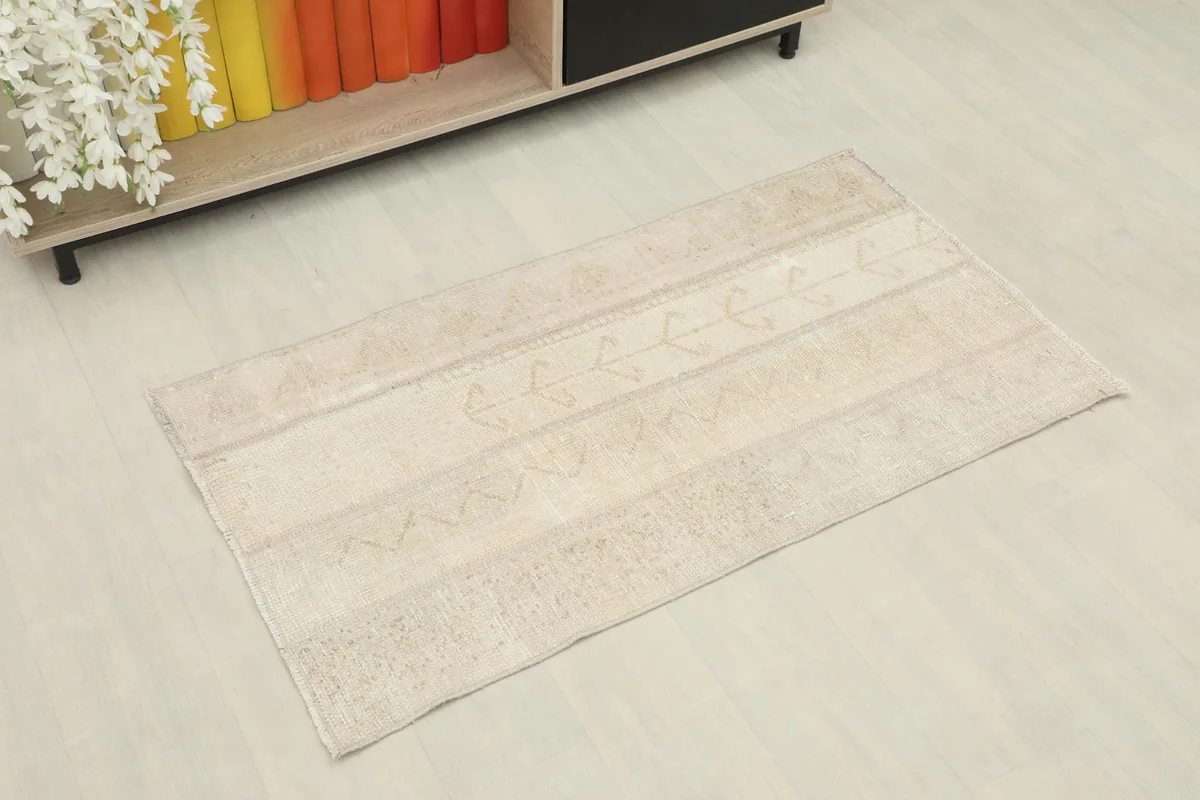 Angled view of the mini rug, showing its placement next to a small cabinet
