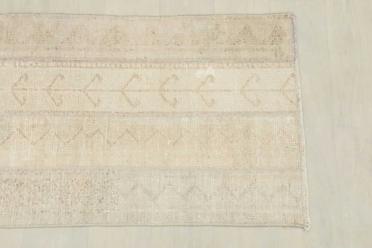 Overhead view showcasing the subtle banded geometric patterns across the rug