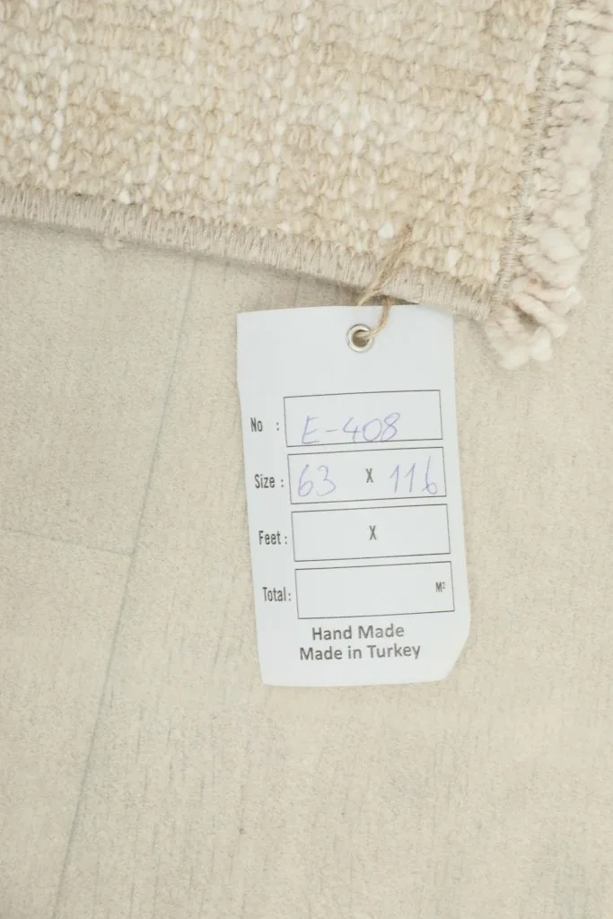 Close-up of the product tag indicating the rug's dimensions and origin