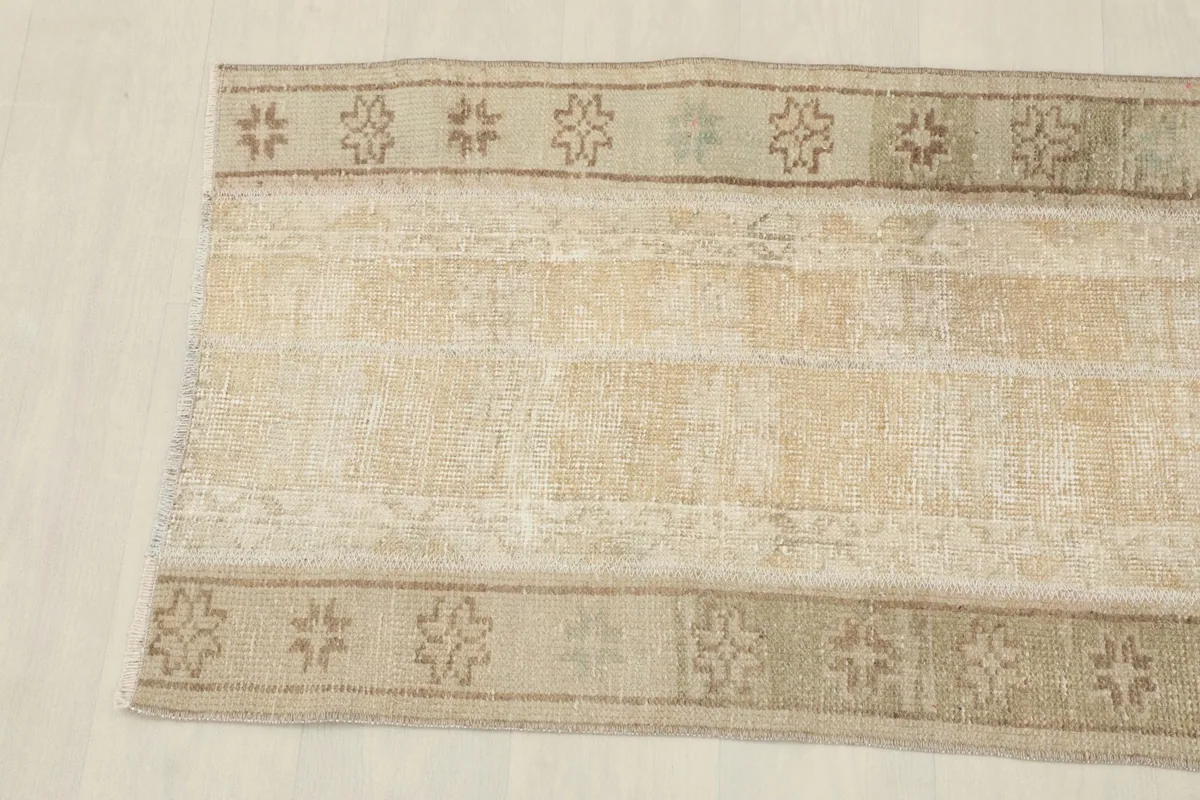 Close-up view of the other end of the rug, highlighting the subtle color variations and wear.