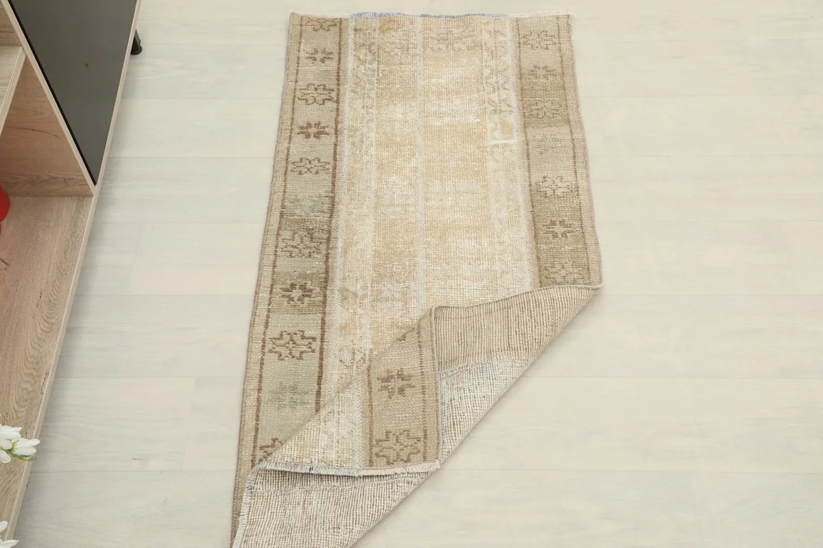 Rug partially folded, displaying both the top surface and the back of the textile.