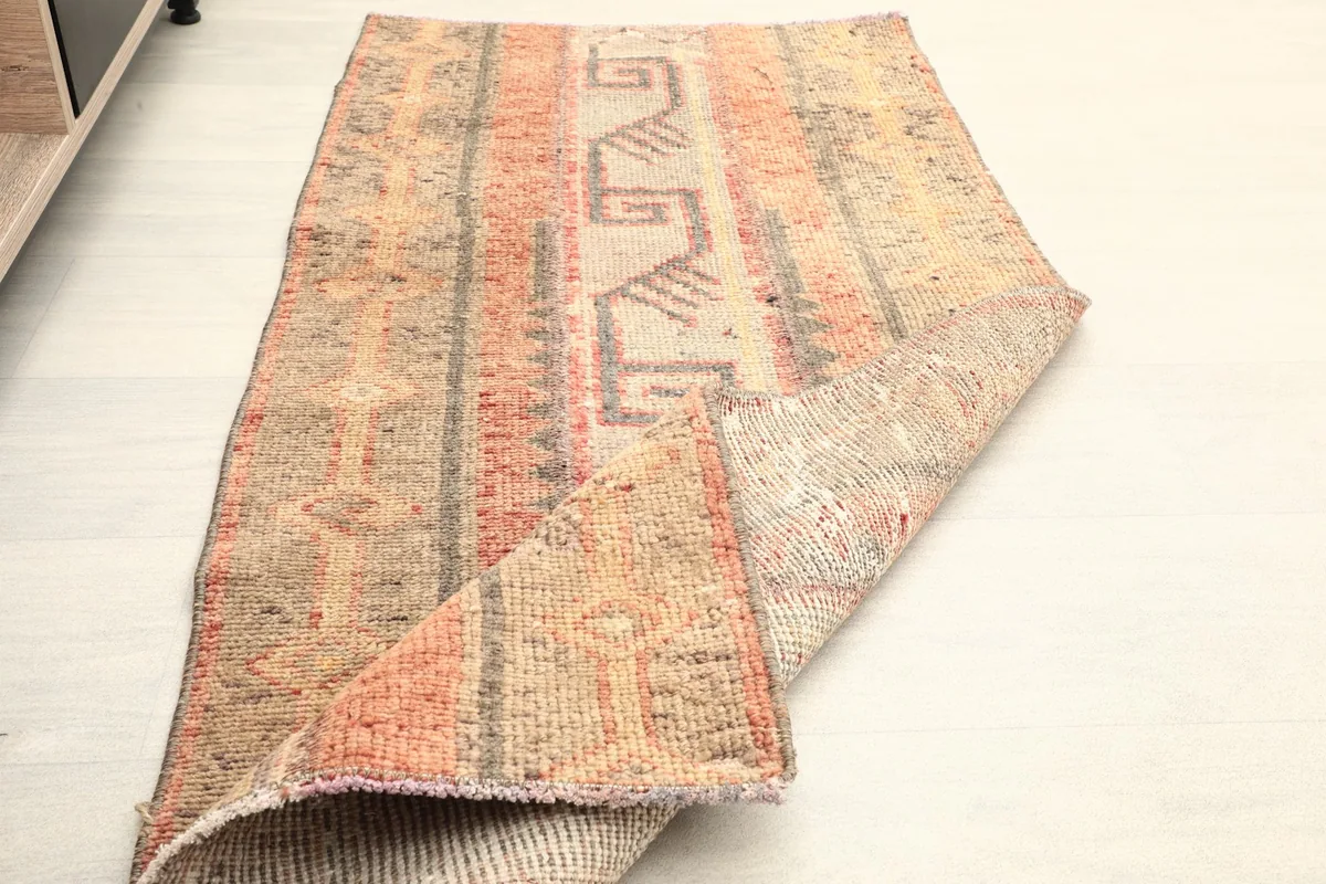 The rug folded to show its flexibility and the thickness of the low pile.